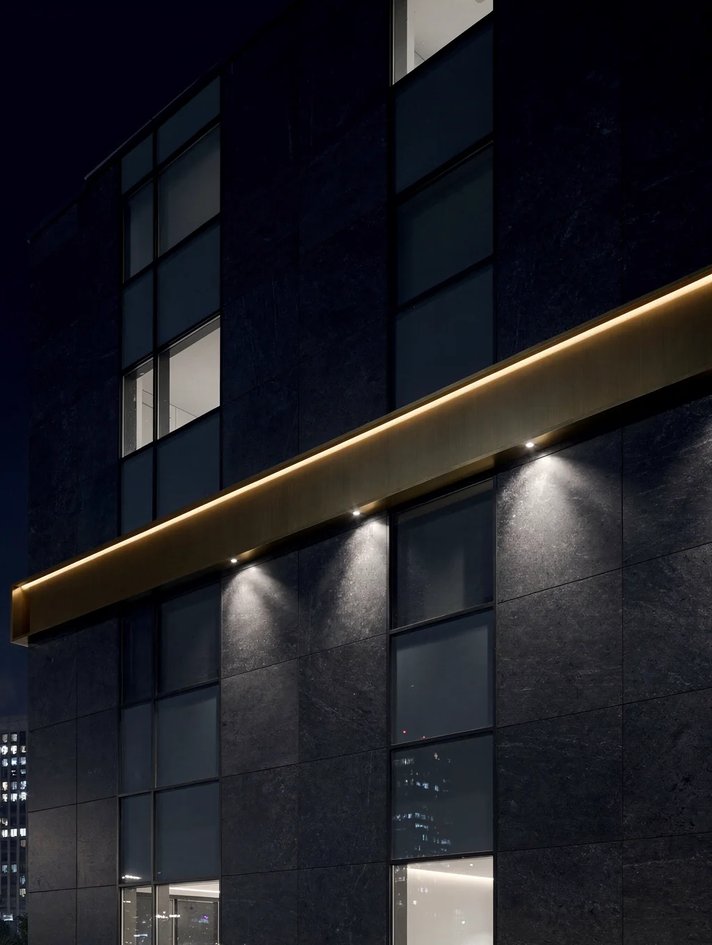Modern architectural facade with natural stone and warm evening lighting